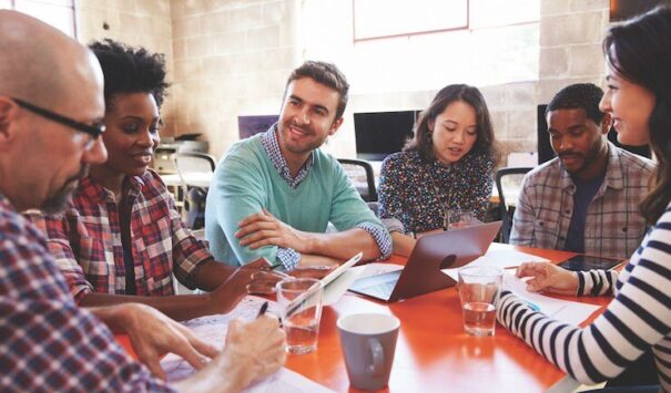 Image shows diverse community leaders working together to solve problems. Image shows diverse community leaders working together to solve problems.